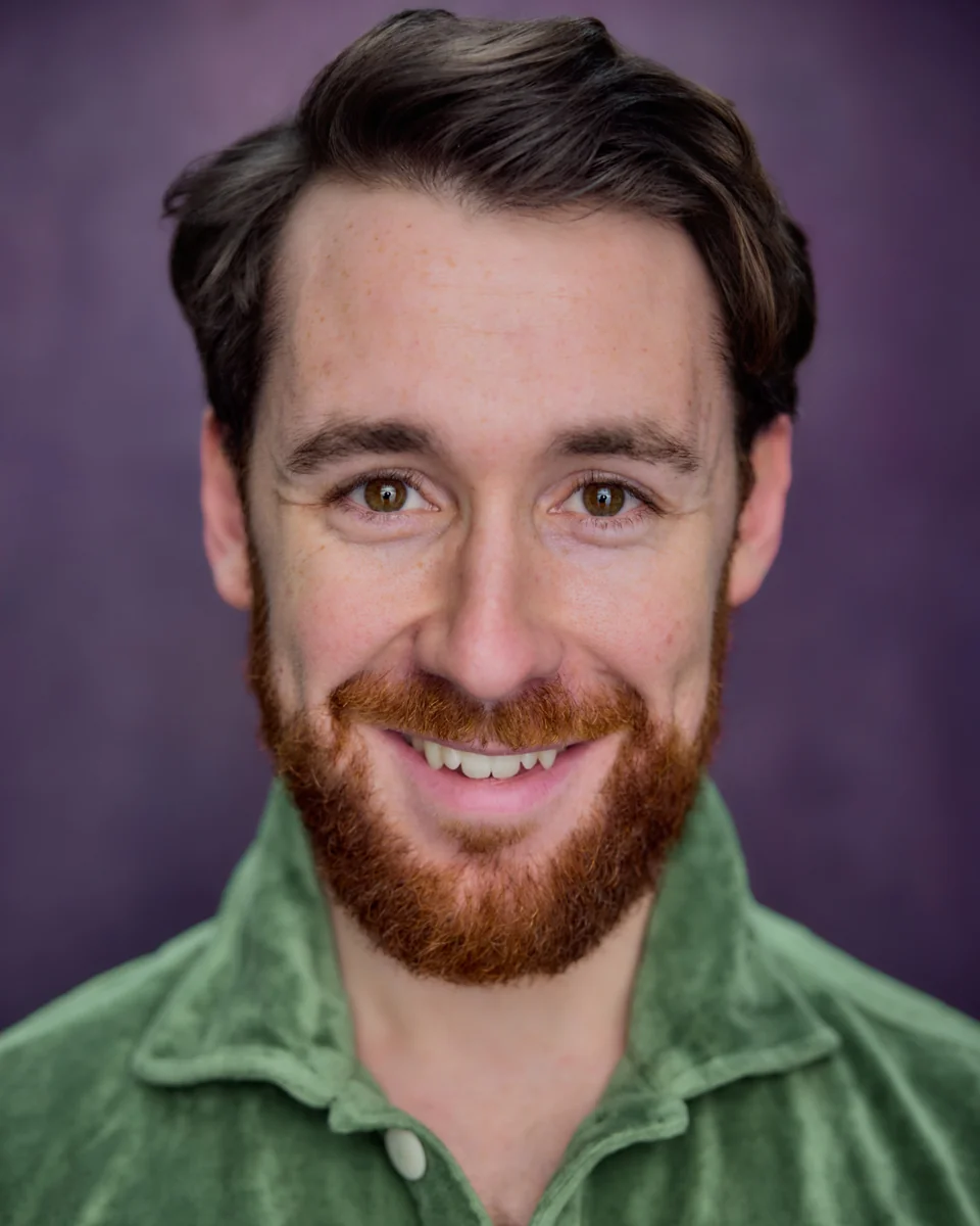 Nick Hyde smiling, in a green shirt