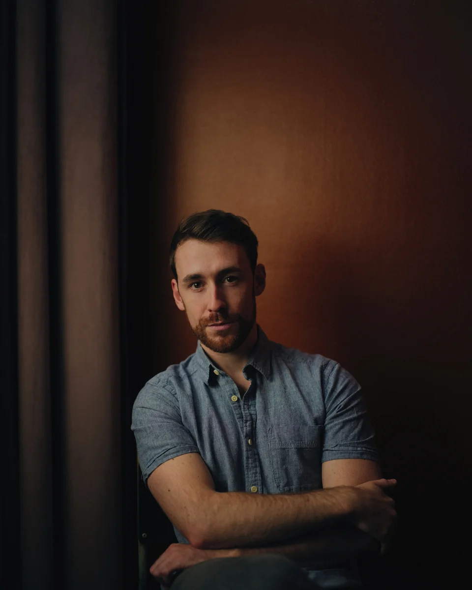 Seated portrait beside a window, photographed by Phil Sharp